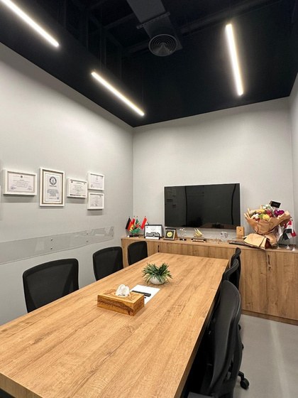 Small meeting room with a screen and certificates on the wall
