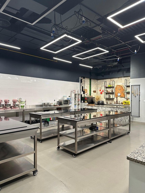 The Training Kitchen with mobile induction prep tables and equipment along the back wall