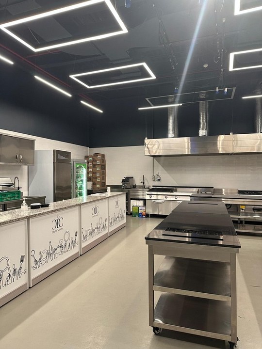 The kitchen set up for a class with the pass counter alongside