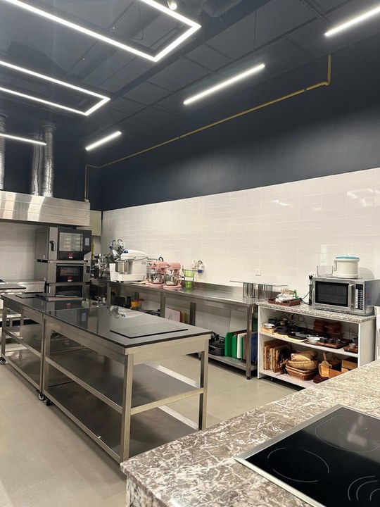 Induction table beside the stone counter and small appliance shelving